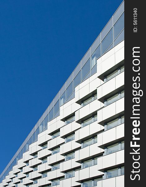 Modern building on a background of the blue sky. Modern building on a background of the blue sky