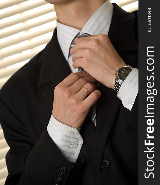 Young Buisnessman Ties Necktie