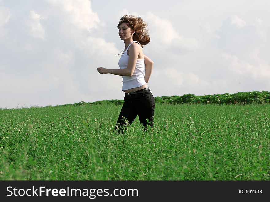 A beautiful girl running on the field