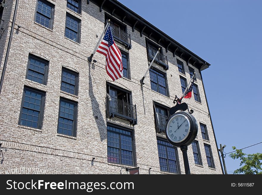 Modern lofts in traditional architecture with a street clock in front. Modern lofts in traditional architecture with a street clock in front