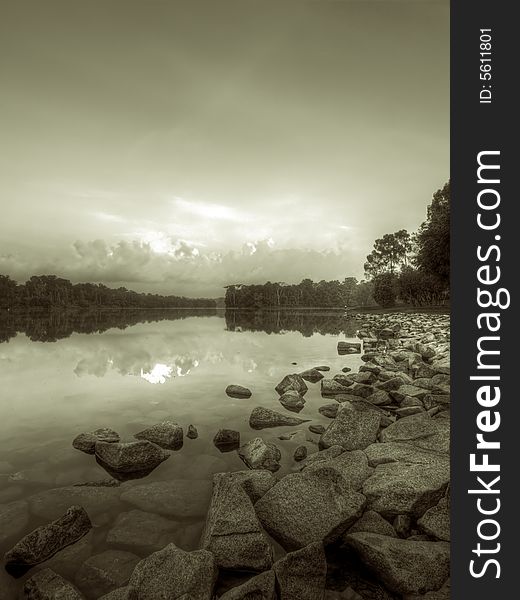 Rocky shore of a reservoir in black and white
