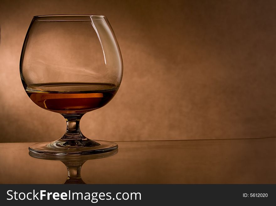 Cognac glass on vintage background