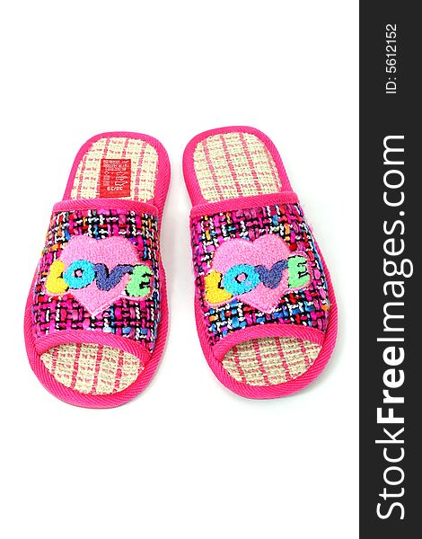 Multi-coloured slippers with heart on white background