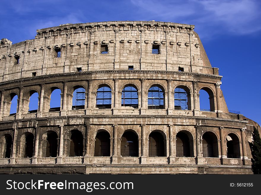 Antique colosseum in Rome over blue sky