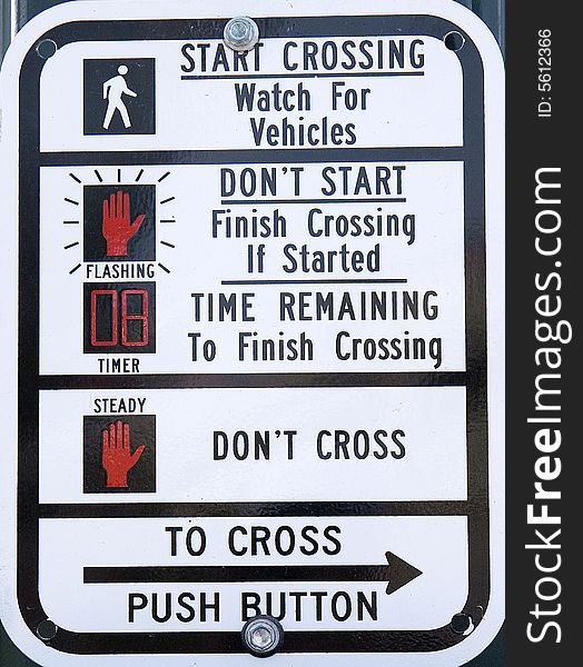 Street sign at a busy crosswalk. Street sign at a busy crosswalk