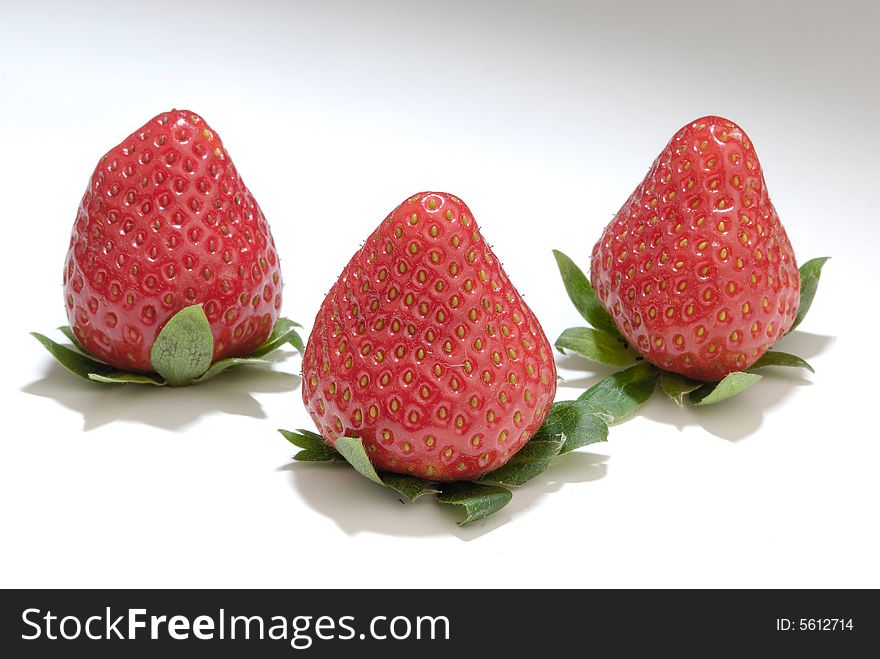 Three isolated white background red strawberry