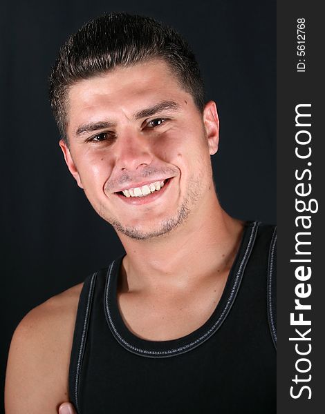 Male model in studio against a dark wall