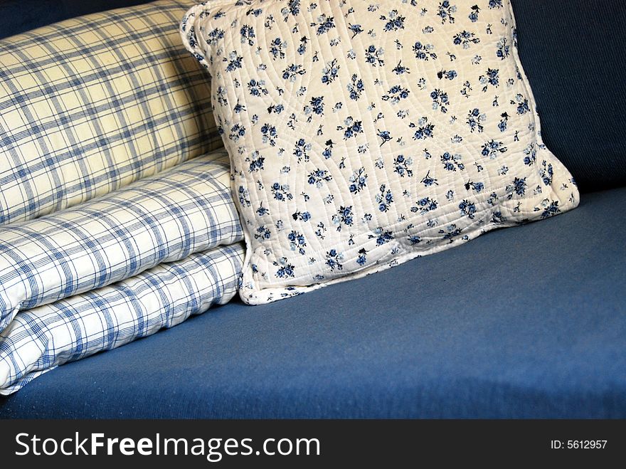Blue and white cushions with flowers and lines