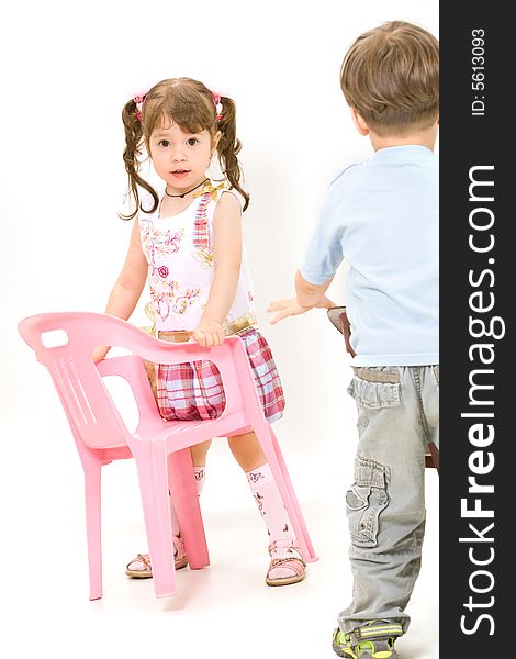 Cheerful little children with pink chair isolated over white. Cheerful little children with pink chair isolated over white