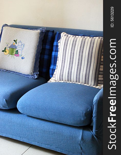 A blue sofa with cushions