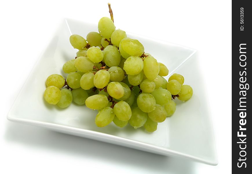 Fresh bunch of green grapes in white bowl and isolated on white background. Fresh bunch of green grapes in white bowl and isolated on white background