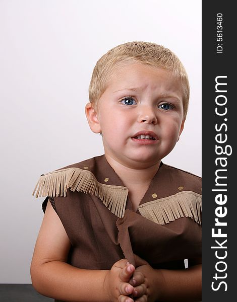 Toddler wearing a cowboy shirt with brown fringing