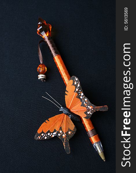 Orange covered pen with crystal and butterfly. Orange covered pen with crystal and butterfly