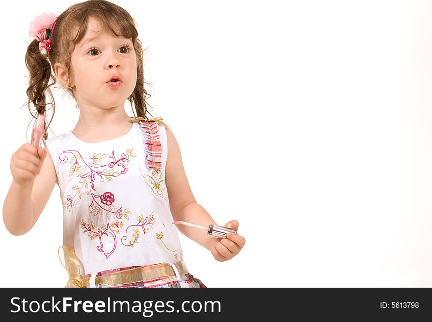 Adorable little girl applying make-up with lipstick