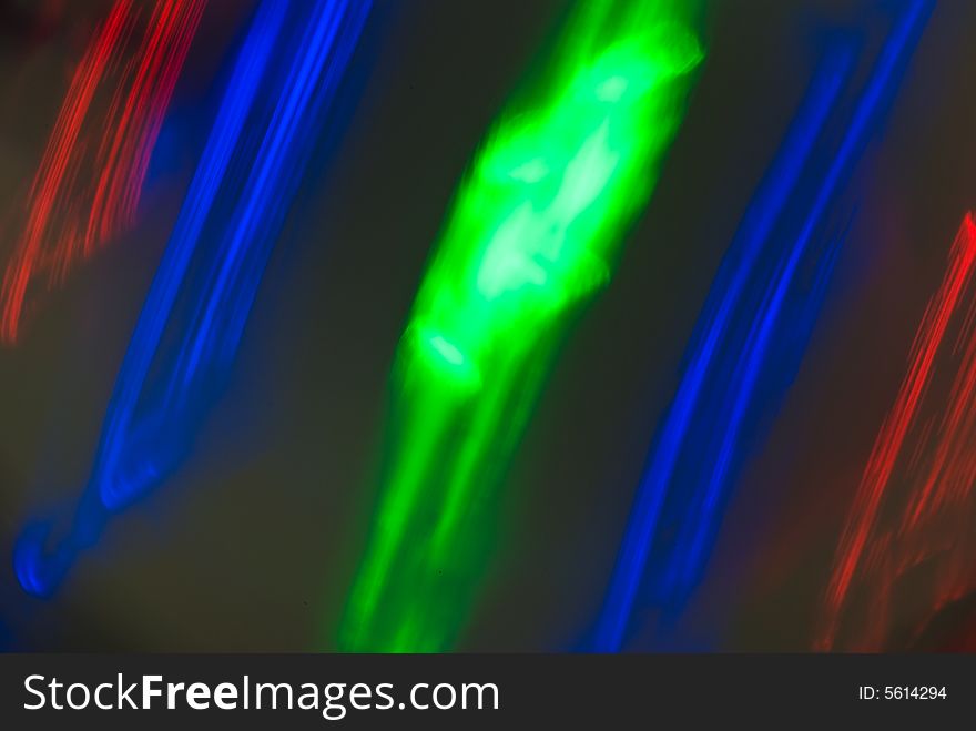 An abstract close up of some coloured LED's spinning within a child's toy. An abstract close up of some coloured LED's spinning within a child's toy