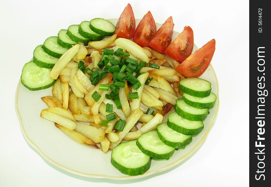 Fried potato with some slices of cucumber and tomato. Fried potato with some slices of cucumber and tomato.