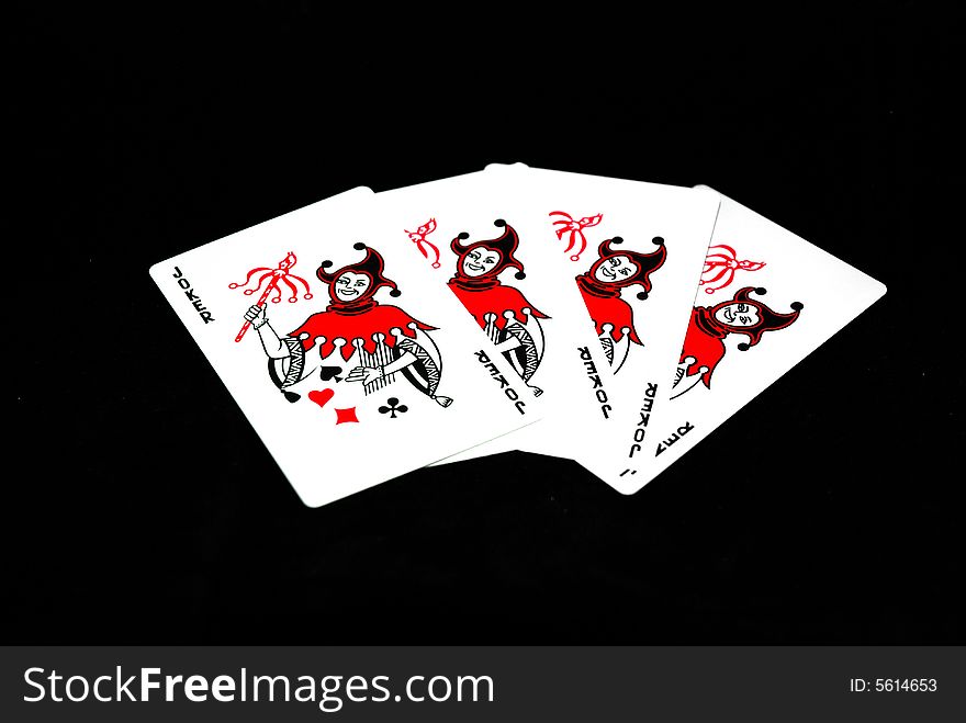 Four playing cards (jokers) on a blackground. Four playing cards (jokers) on a blackground.