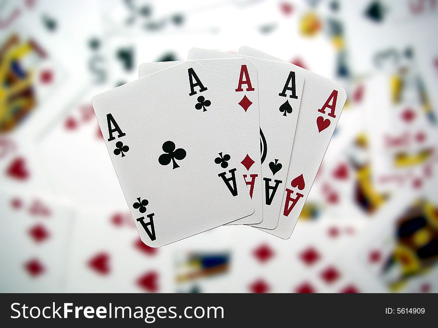 Poker cards showing a four-to-ace combination on a blurry background. Poker cards showing a four-to-ace combination on a blurry background