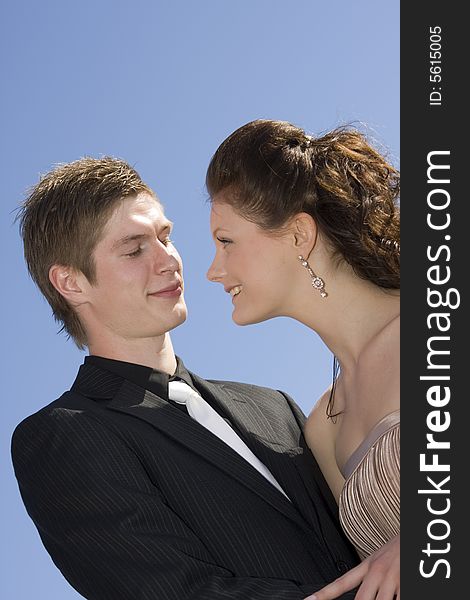 Young beautiful happy couple on sky background. Young beautiful happy couple on sky background