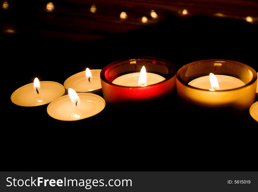 Decorative candles burning photographed in the dark