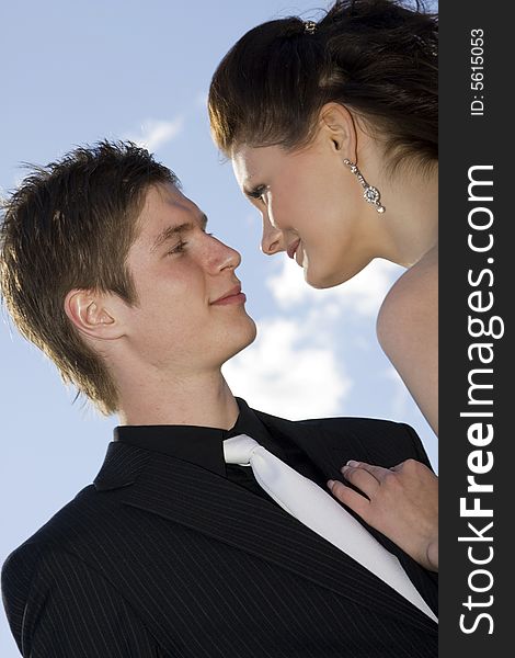 Young beautiful happy couple on sky background. Young beautiful happy couple on sky background