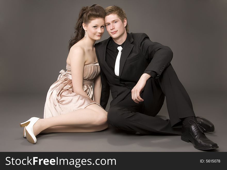 Portrait of a young beautiful couple on gray background