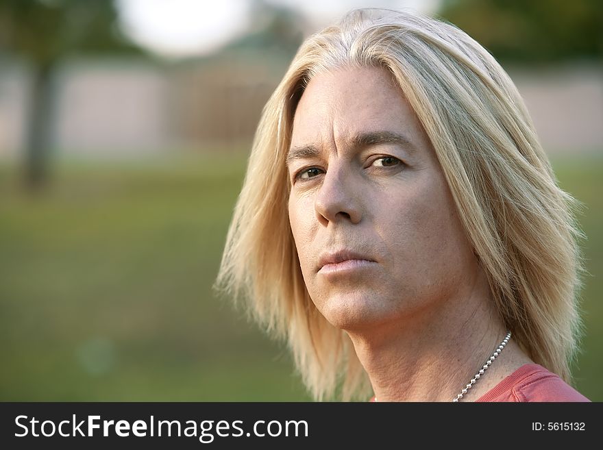 Youthful adult male with long blonde hair. Youthful adult male with long blonde hair