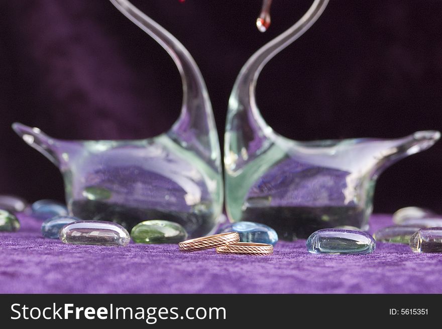 Wedding rings on the glass swans