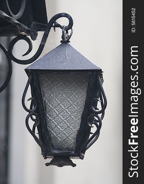 Lantern at the canopy of an old brick building, simulating an old, antique oil lantern.