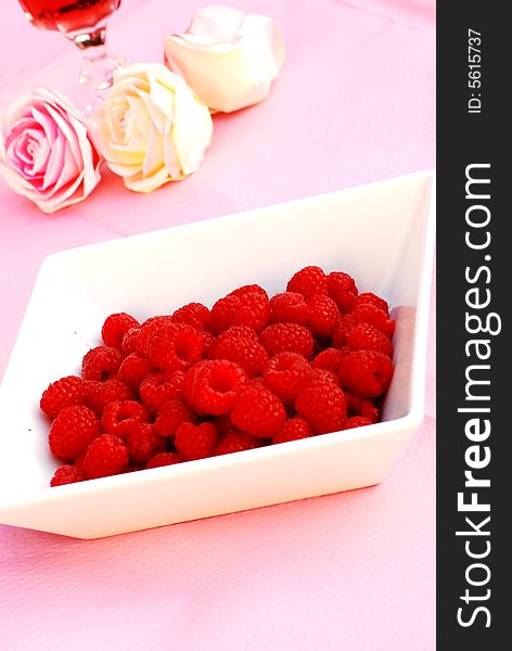 Delicious summer raspberries in a white dish