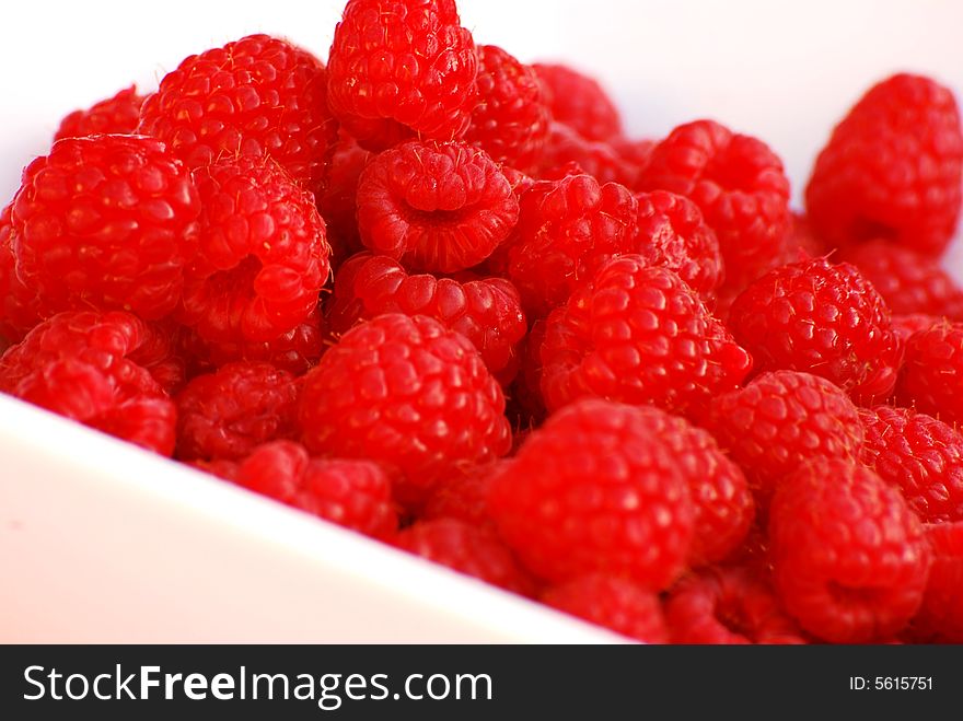 Delicious summer raspberries in a white dish