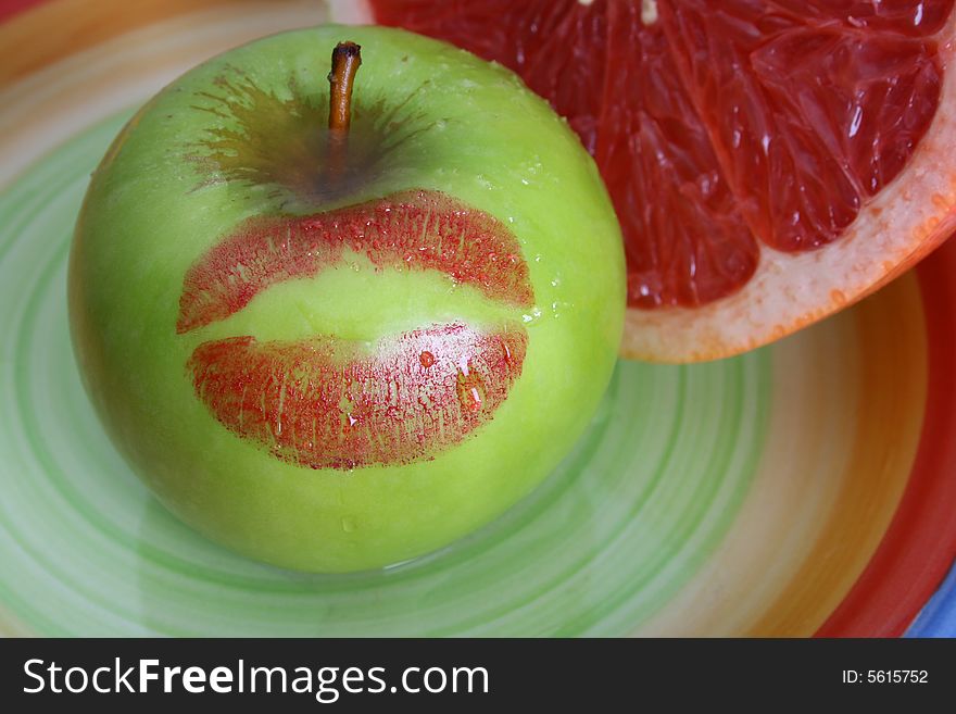 Sliced Pomelo and a green apple with a red kiss. Sliced Pomelo and a green apple with a red kiss