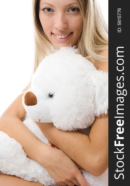 Young girl hugging teddy bear, eyes closed, Stock image