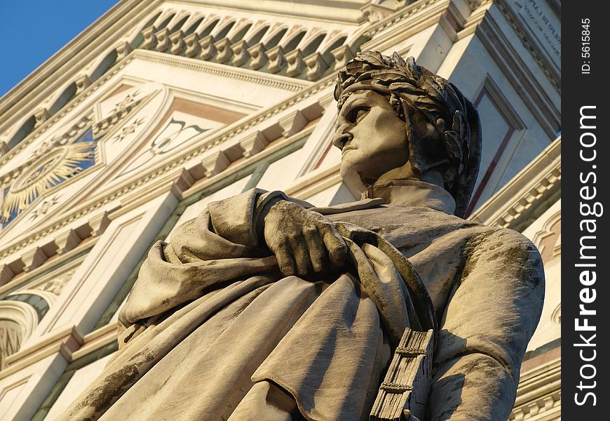 A wonderfull shot of the statue of Dante Alighieri and santa croce church in florence - Italy