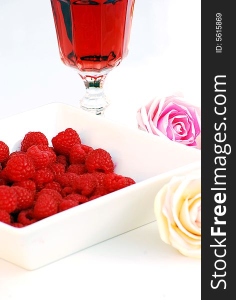 Delicious summer raspberries in a white dish