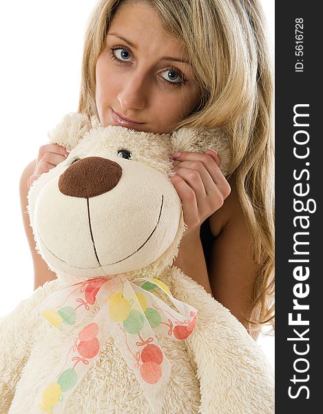 Close-up lovely young blonde girl with teddy bear isolated on white background