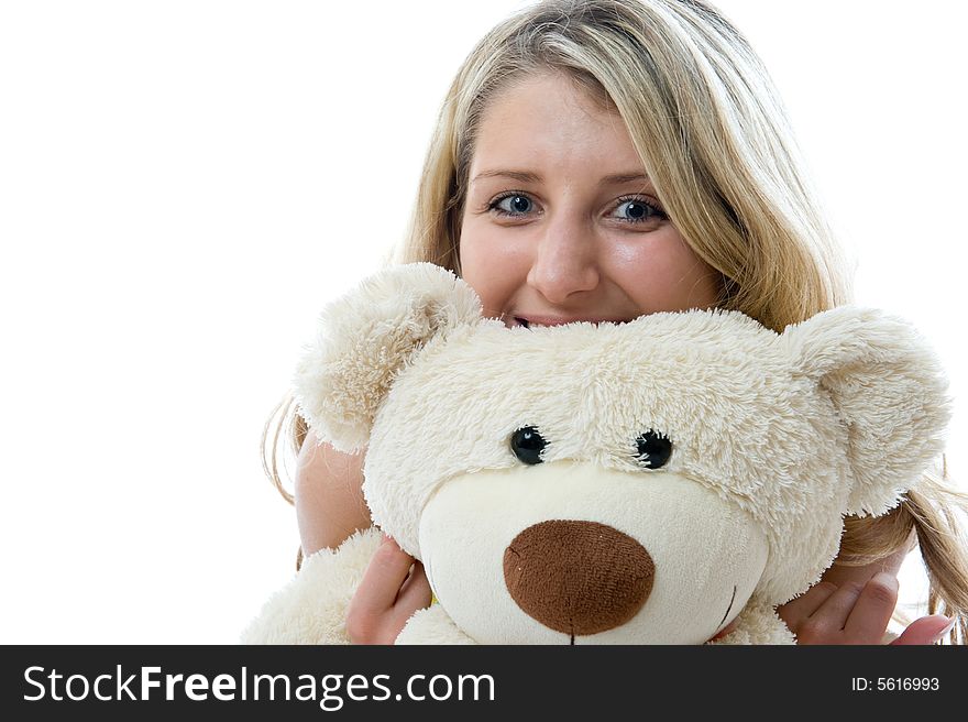 Happy little girl with teddy bear on a bedroom isolated on white background