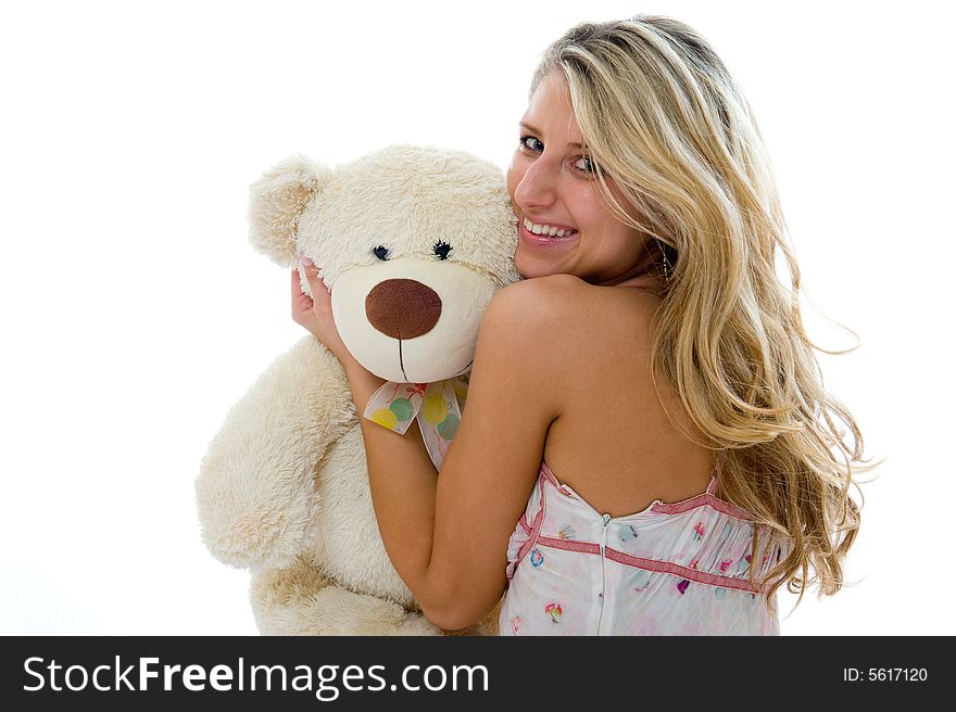 Happy sexy girl with teddy bear on a bedroom isolated on white background