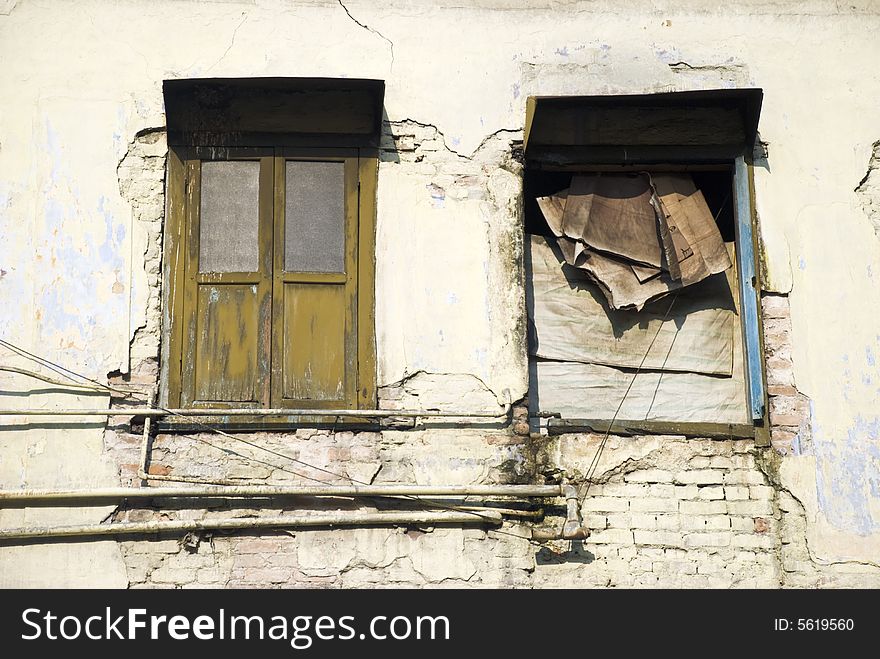 An old dilapidated beige building. An old dilapidated beige building