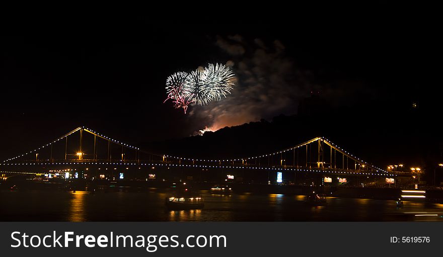 Fireworks in black sky over bridge in Kiev
