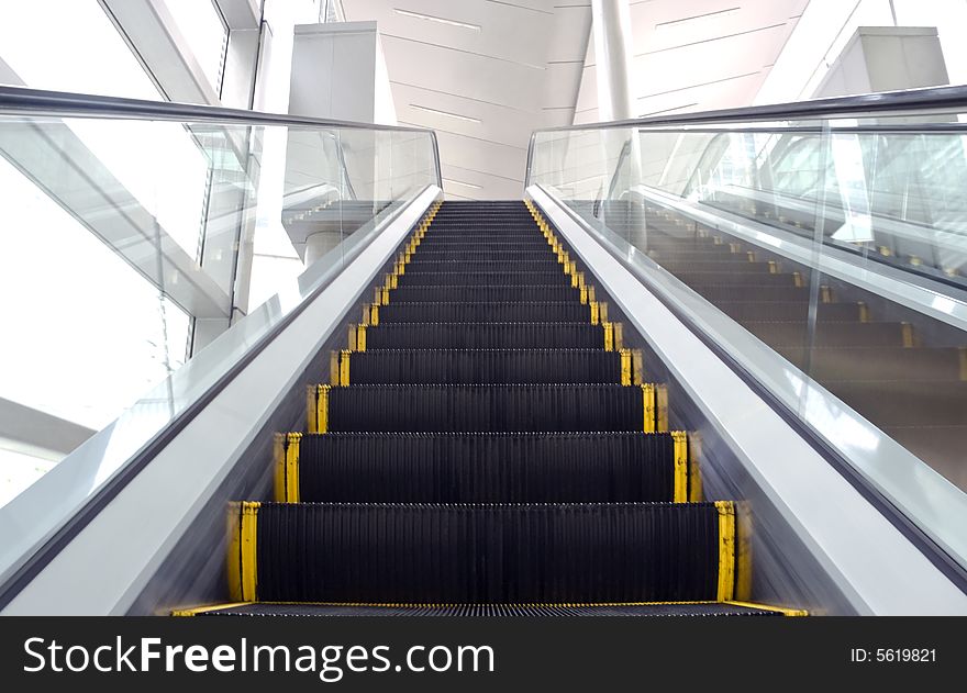 An image of an escalator with some motion blur