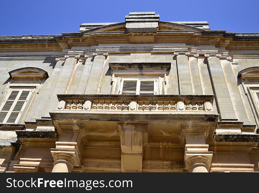 Ancient windows and balconies of a building in the classical style