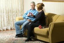 A Couple With Wine Glasses On A Couch-Horizontal. Stock Photography A Couple With Wine Glasses On A Couch-Horizontal. Stock Photography
