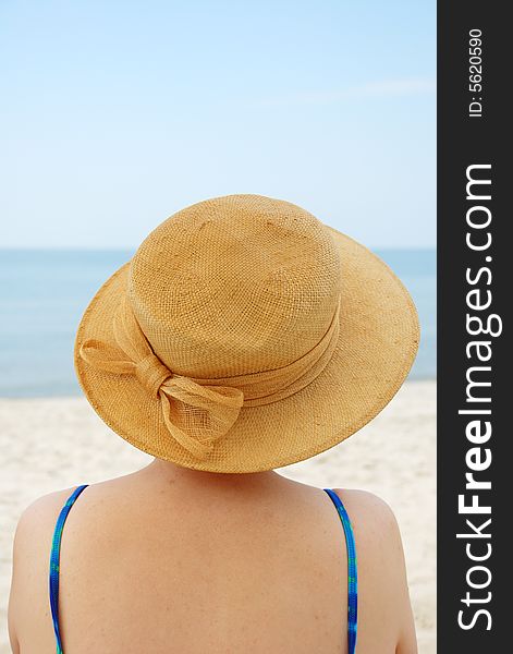 Women in hat on sea background