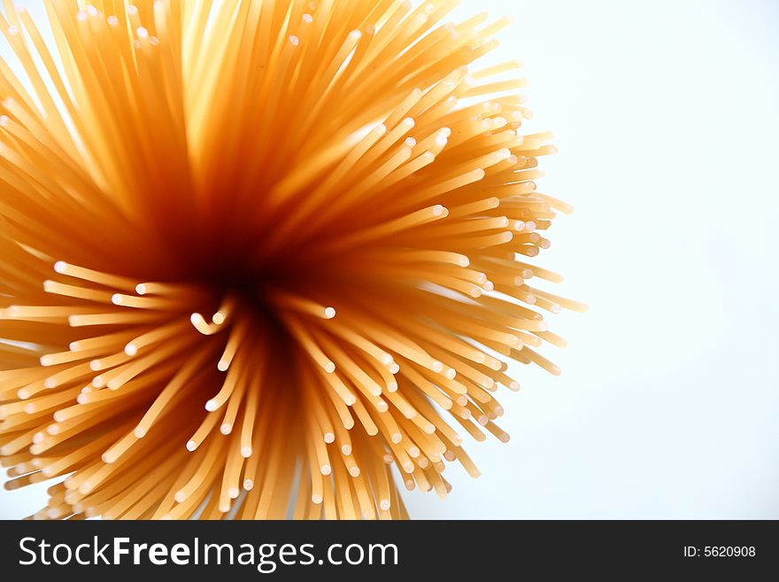 A close-up shot of a bunch of uncooked spaghetti.