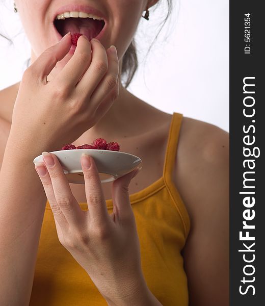 Teen girl eats raspberry open mouth enjoying. Teen girl eats raspberry open mouth enjoying