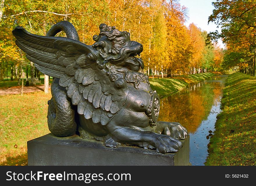 Sculpture of the Dragon on foreground of the autumn landscape. Sculpture of the Dragon on foreground of the autumn landscape