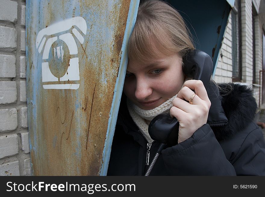 Upset urban girl with street phone. Upset urban girl with street phone