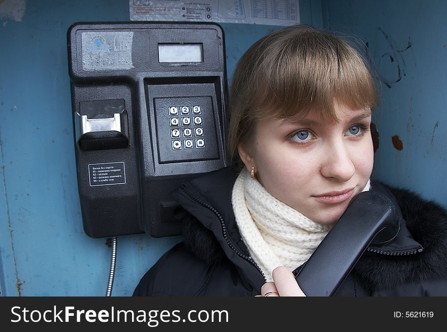 Upset urban girl with street phone. Upset urban girl with street phone