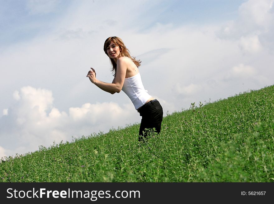 A beautiful girl jumping on the field